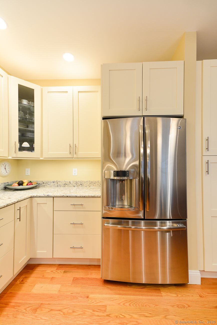 10 Fort Hill Road, Unit 3B Groton, CT 06340 - Photo 7 of 24 a kitchen with stainless steel appliances granite countertop a refrigerator a stove and a sink with granite countertops