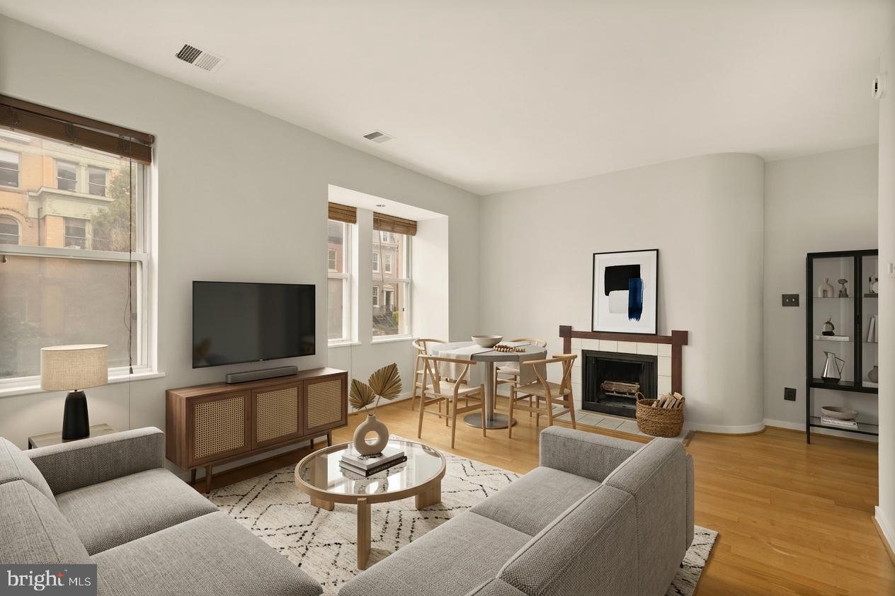 2114 N Street Northwest, Unit 11 Washington, DC 20037 - Photo 11 of 23 a living room with furniture flat screen tv and a fireplace