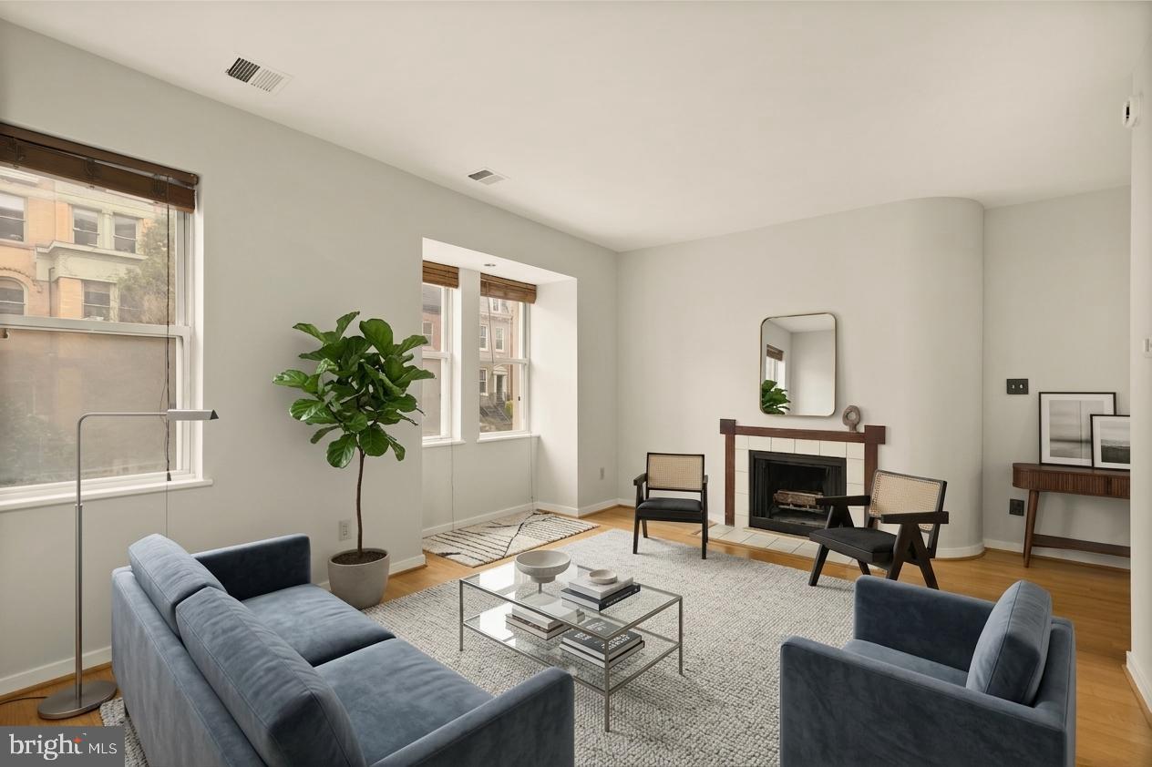 2114 N Street Northwest, Unit 11 Washington, DC 20037 - Photo 12 of 23 a living room with furniture potted plant and a fireplace