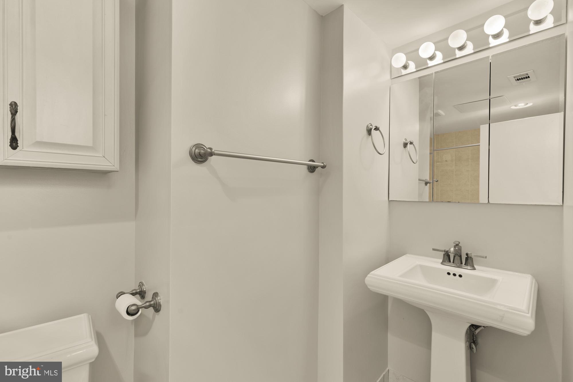 2114 N Street Northwest, Unit 11 Washington, DC 20037 - Photo 20 of 23 a bathroom with a sink a mirror and shower