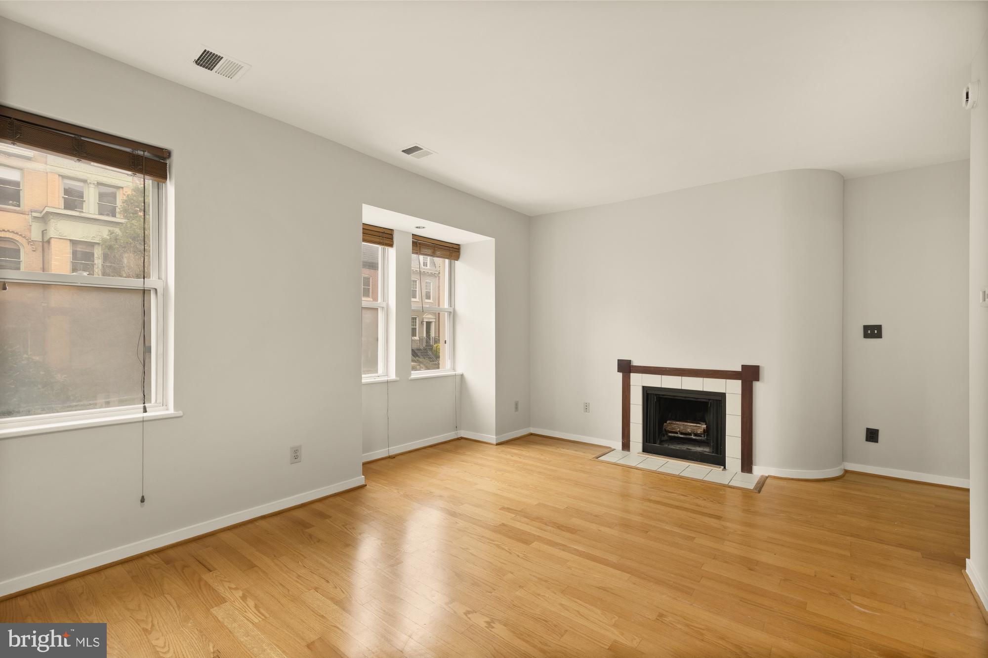 2114 N Street Northwest, Unit 11 Washington, DC 20037 - Photo 10 of 23 a view of empty room with a fireplace