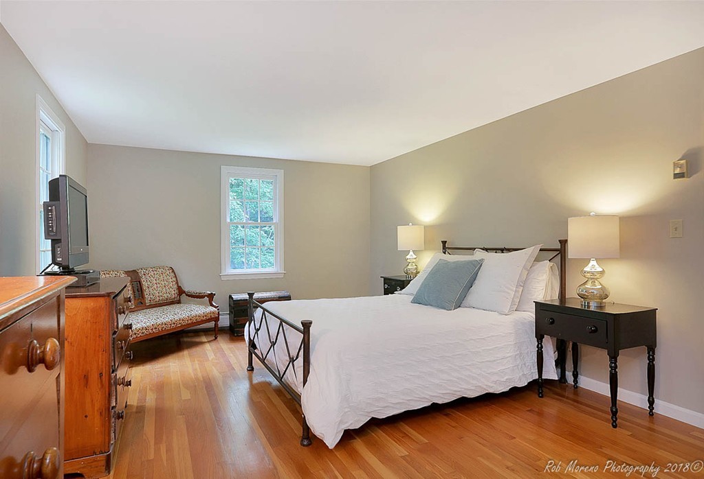 17 Janes Road Boxford, MA 01921 - Photo 17 of 29 a bedroom with a bed and a wooden floor
