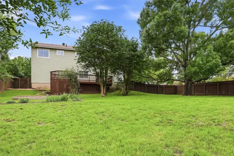 a house with a big yard and large trees