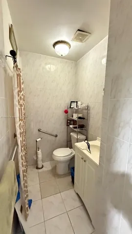 a kitchen with stainless steel appliances kitchen island granite countertop a sink and white cabinets