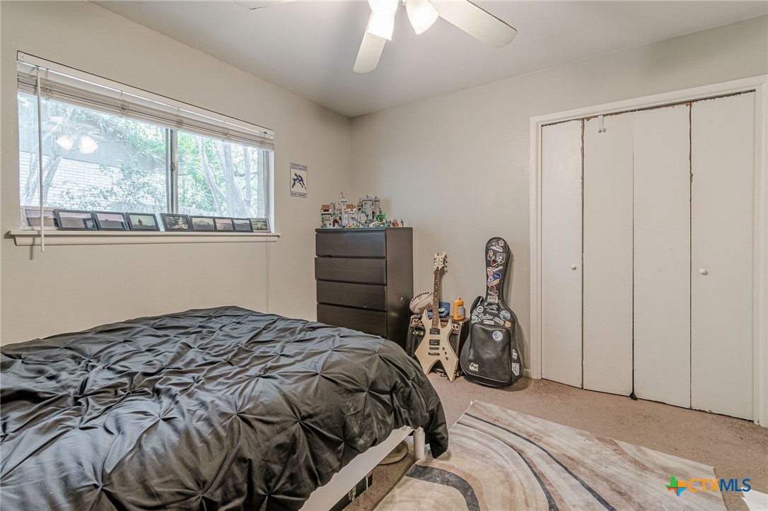 133 Algarita Road San Marcos, TX 78666 - Photo 12 of 43 a bedroom with a bed and a window