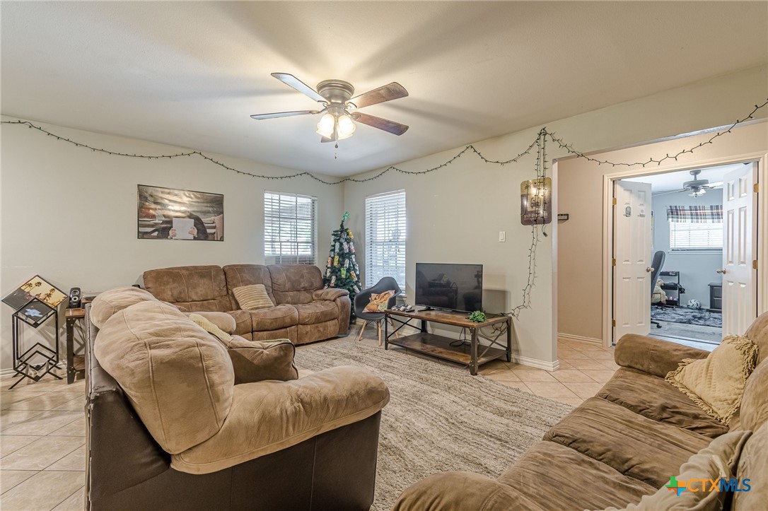 133 Algarita Road San Marcos, TX 78666 - Photo 15 of 43 a living room with furniture a ceiling fan and a flat screen tv
