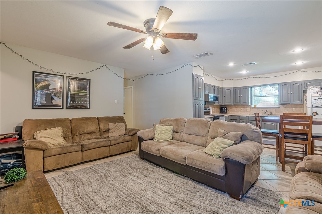 133 Algarita Road San Marcos, TX 78666 - Photo 18 of 43 a living room with furniture and a chandelier