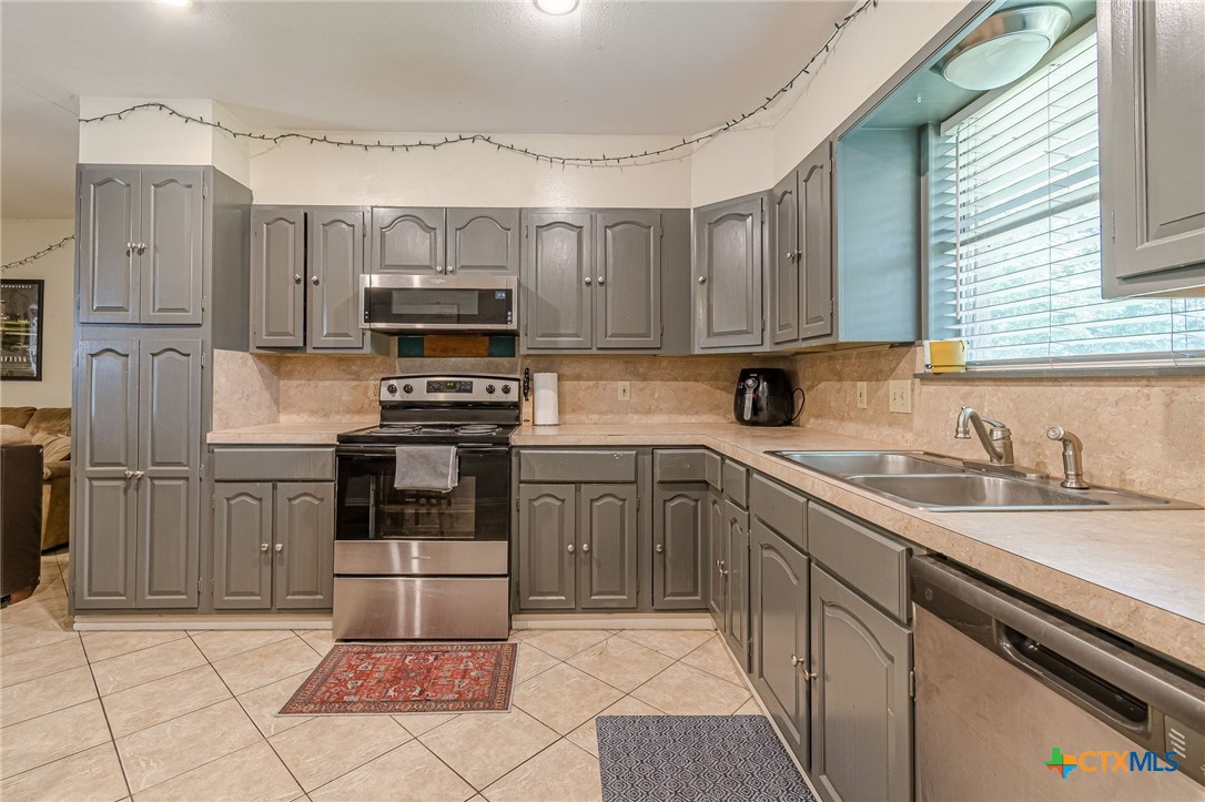 133 Algarita Road San Marcos, TX 78666 - Photo 25 of 43 a kitchen with a sink stove and refrigerator