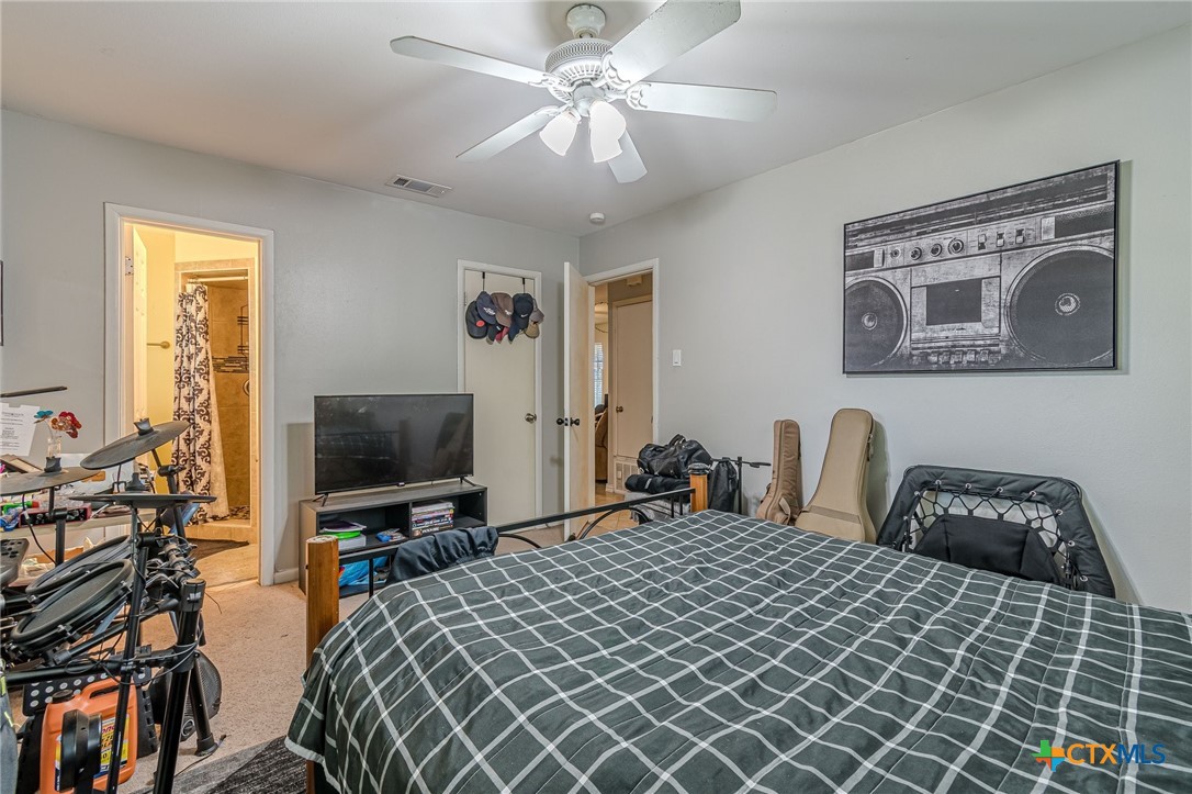 133 Algarita Road San Marcos, TX 78666 - Photo 31 of 43 a bedroom with a bed and a flat screen tv