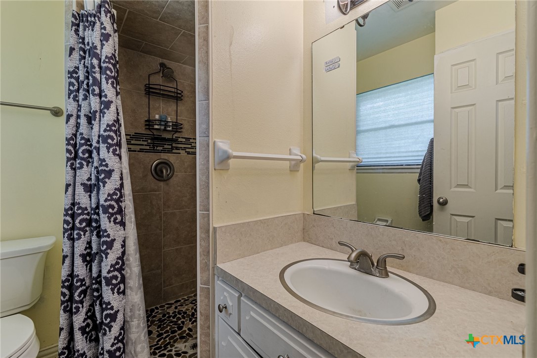133 Algarita Road San Marcos, TX 78666 - Photo 32 of 43 a bathroom with a sink toilet and shower