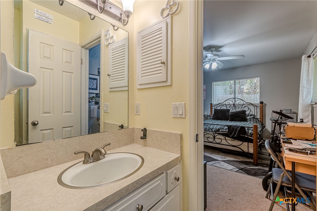 133 Algarita Road San Marcos, TX 78666 - Photo 34 of 43 a en suite bathroom with a double vanity sink and a mirror