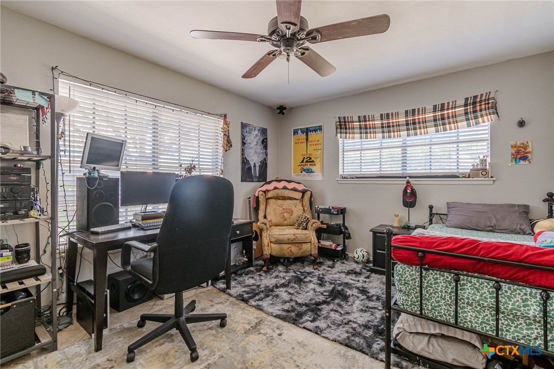 133 Algarita Road San Marcos, TX 78666 - Photo 4 of 43 a bedroom with furniture and a window