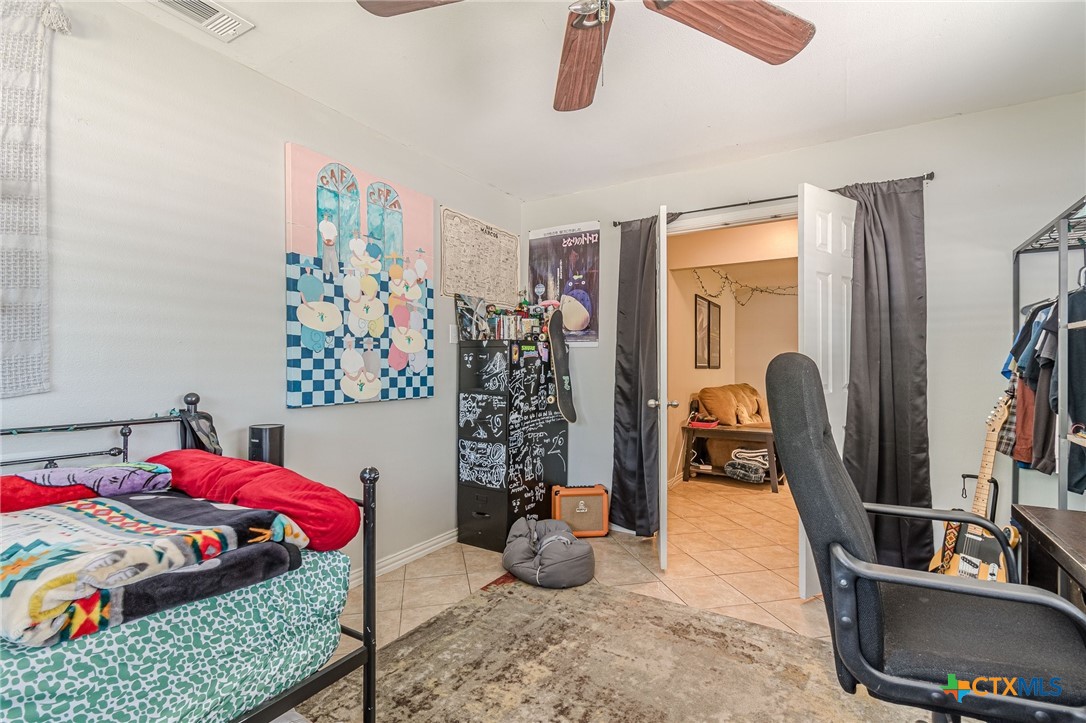 133 Algarita Road San Marcos, TX 78666 - Photo 5 of 43 a bedroom with a bed a couch and dresser