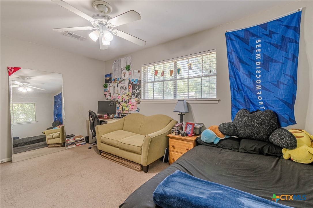 133 Algarita Road San Marcos, TX 78666 - Photo 9 of 43 a bedroom with furniture and a large window