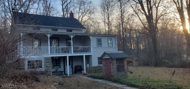 148 Mt Grove Road Califon, NJ 07830 - Photo 3 of 18 a view of a brick house with large windows and a yard