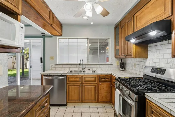 a kitchen with a sink stove and cabinets