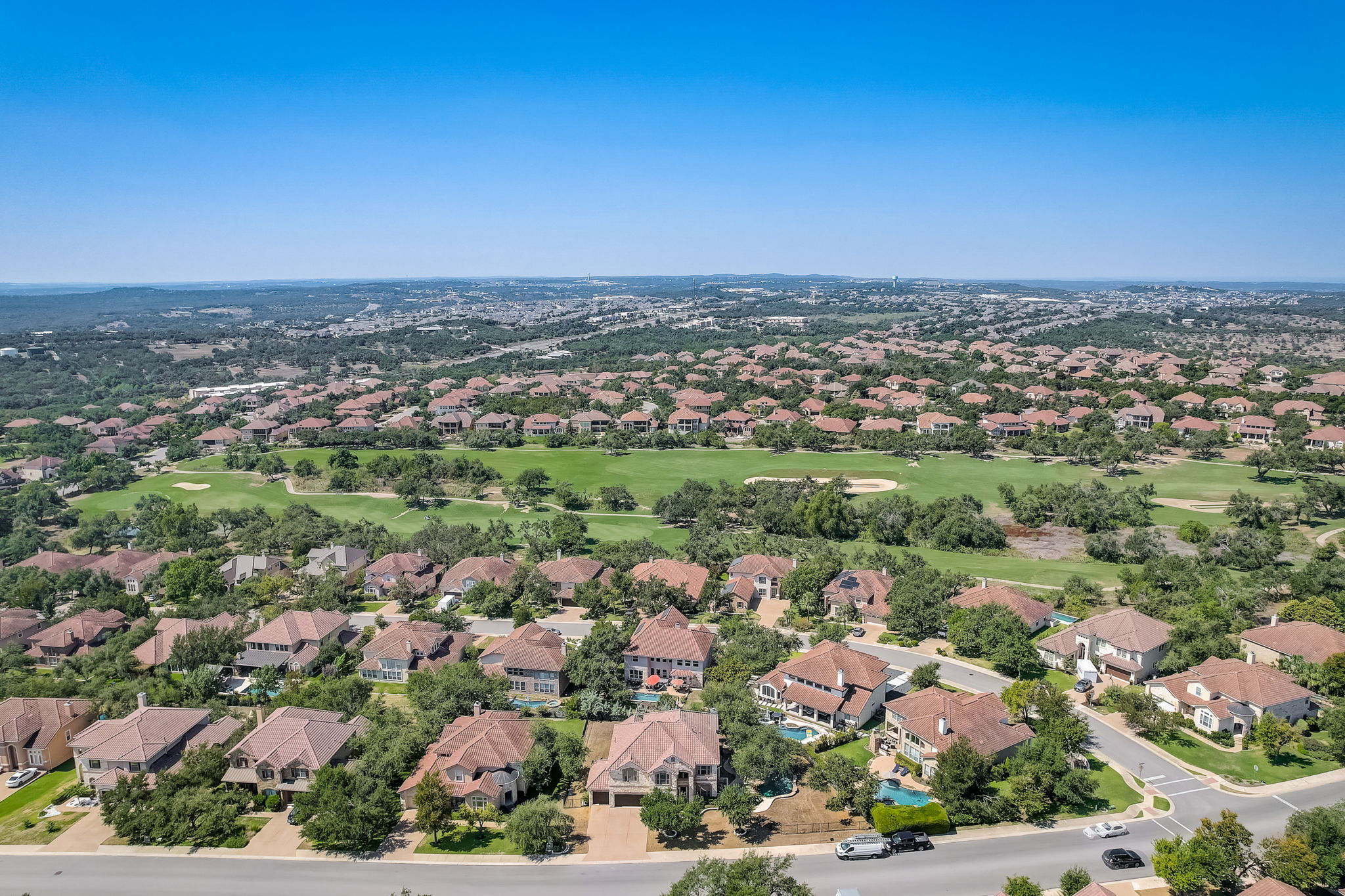 16012 Spillman Ranch Loop Austin, TX 78738 - Photo 37 of 38 An aerial perspective reveals a sprawling residential community nestled beside a lush golf course.