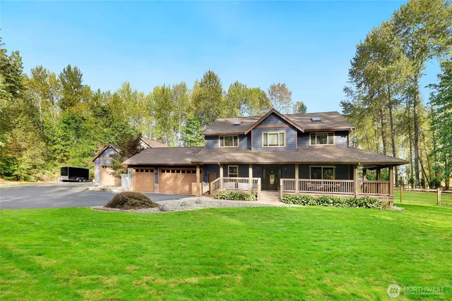 a front view of a house with a yard table and chairs