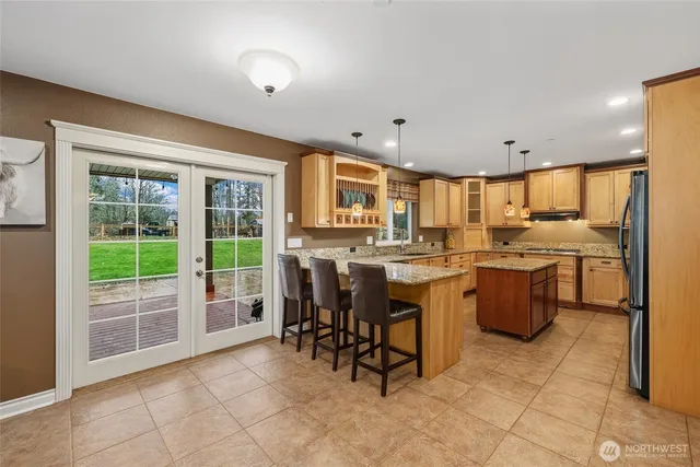 a kitchen with a sink and chairs