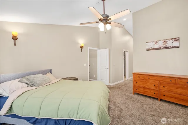 a bedroom with a bed and a chandelier