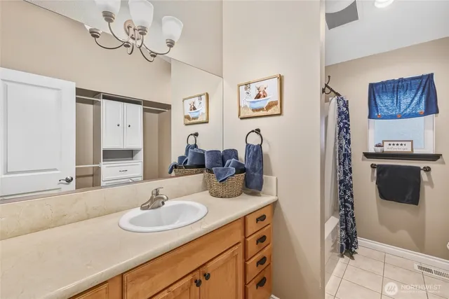 a bathroom with a sink double vanity granite and a mirror