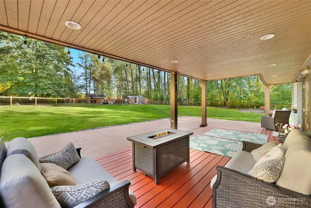 a backyard of a house with a garden and outdoor seating