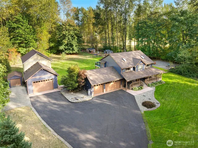 an aerial view of a house with garden space and street view