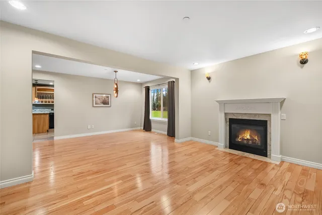 a view of an empty room with window and fire place