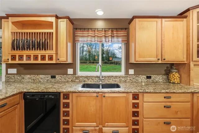 a kitchen with granite countertop a sink and a window
