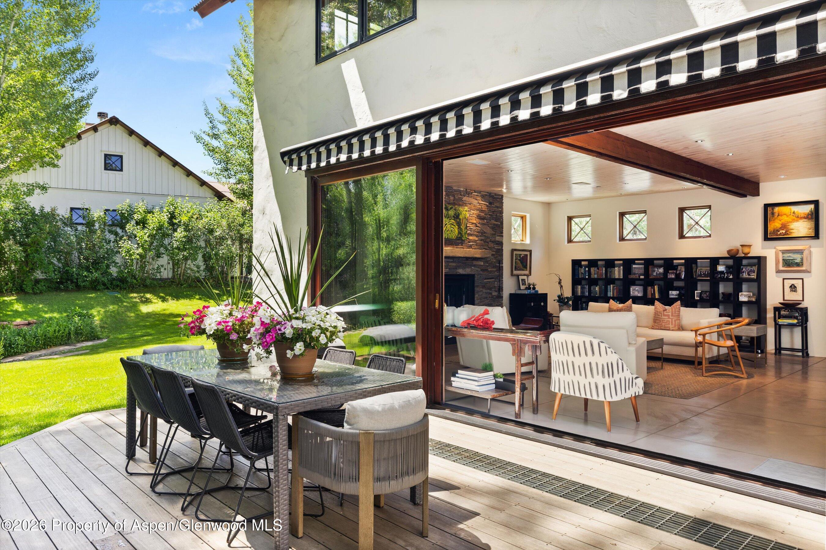 256 Twining Flats Road Aspen, CO 81611 - Photo 4 of 38 a view of living room and patio furniture and garden