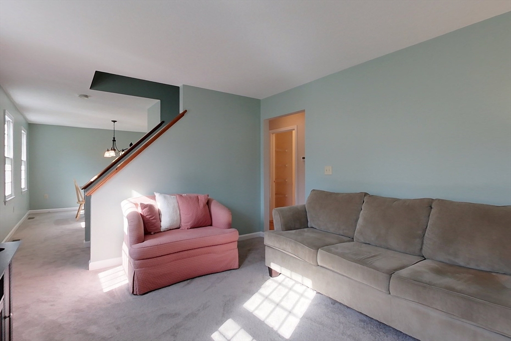 8 Tucker Park, Unit D Pepperell, MA 01463 - Photo 13 of 35 a living room with furniture and a couch