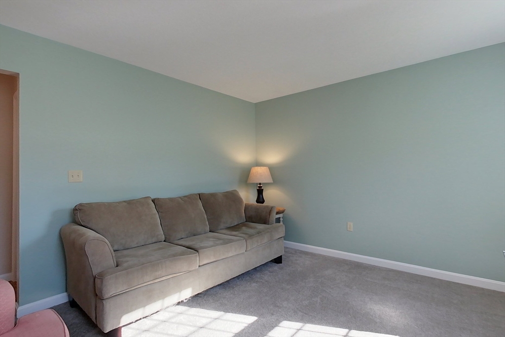 8 Tucker Park, Unit D Pepperell, MA 01463 - Photo 14 of 35 a living room with a couch