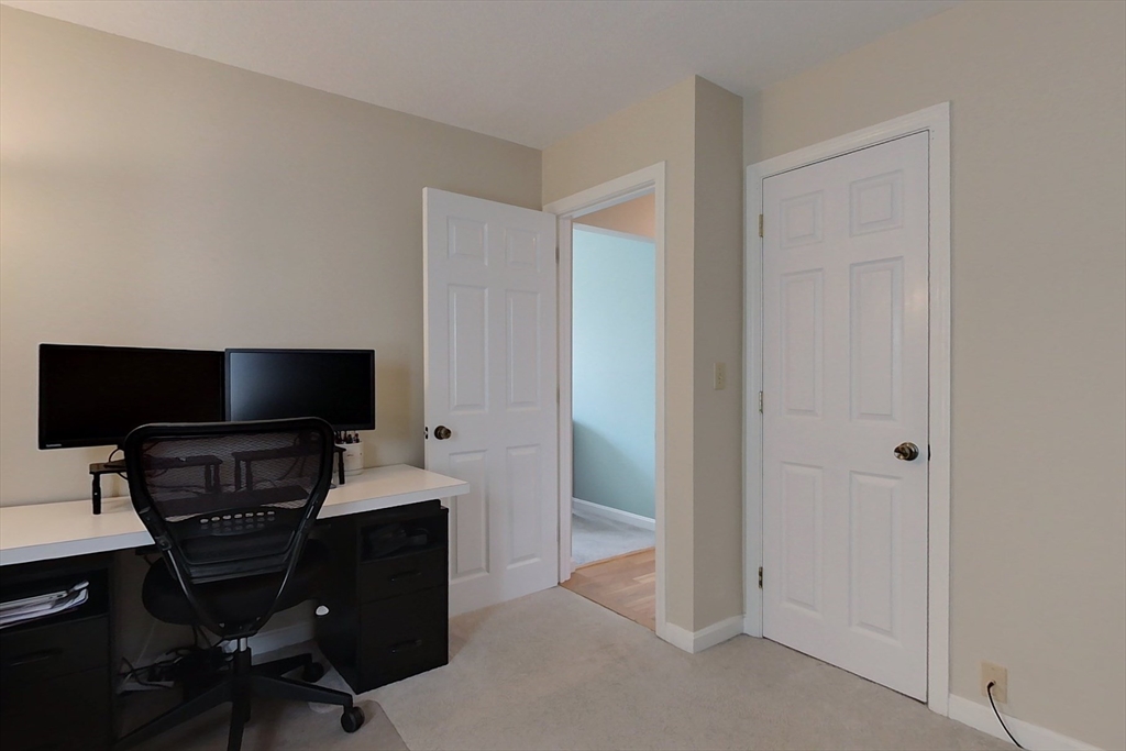 8 Tucker Park, Unit D Pepperell, MA 01463 - Photo 16 of 35 a living room with furniture and a flat screen tv