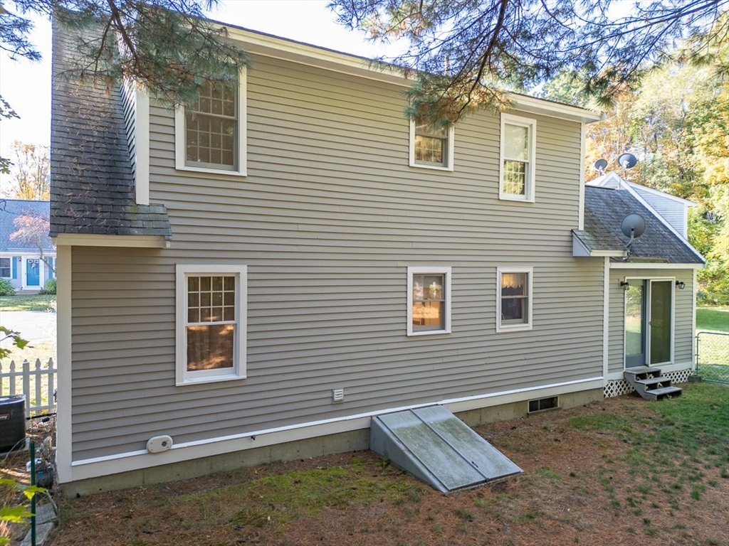 8 Tucker Park, Unit D Pepperell, MA 01463 - Photo 2 of 35 a view of a house with a yard and large tree
