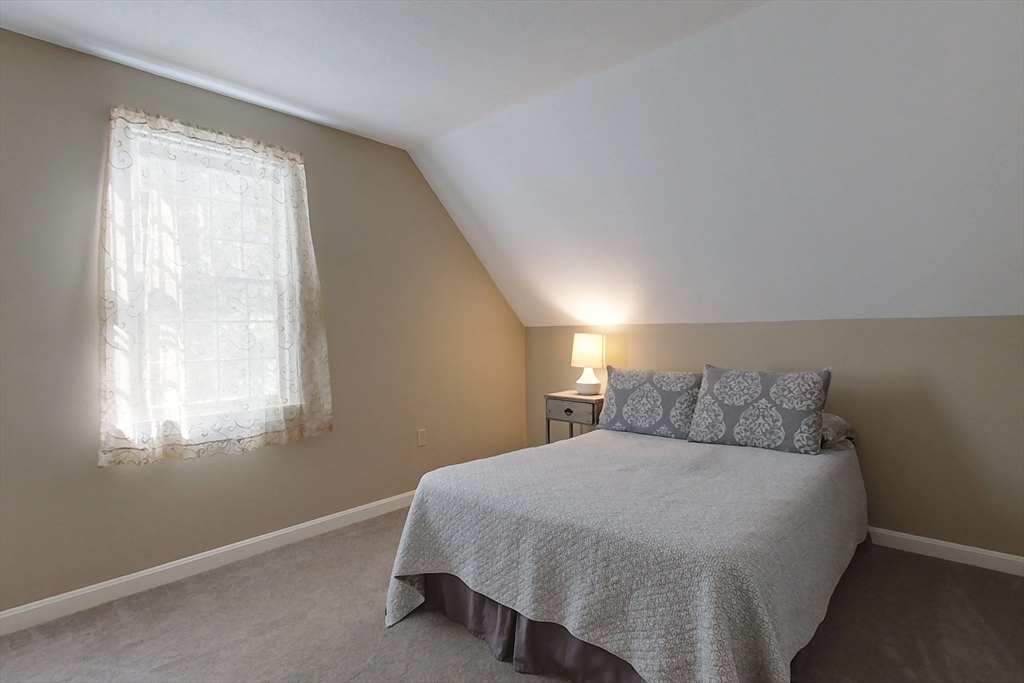 8 Tucker Park, Unit D Pepperell, MA 01463 - Photo 21 of 35 a bedroom with a bed and window