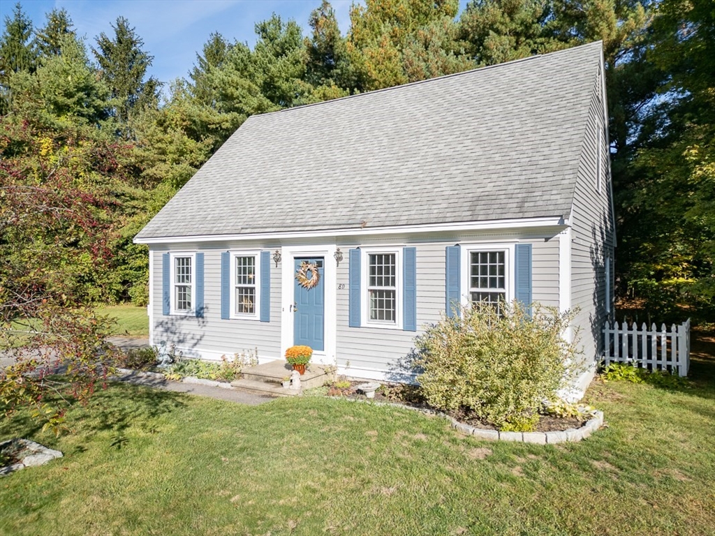 8 Tucker Park, Unit D Pepperell, MA 01463 - Photo 26 of 35 a front view of a house with a yard and outdoor seating
