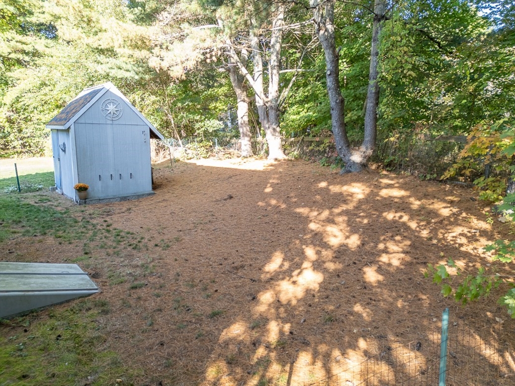 8 Tucker Park, Unit D Pepperell, MA 01463 - Photo 28 of 35 a backyard of a house with lots of green space