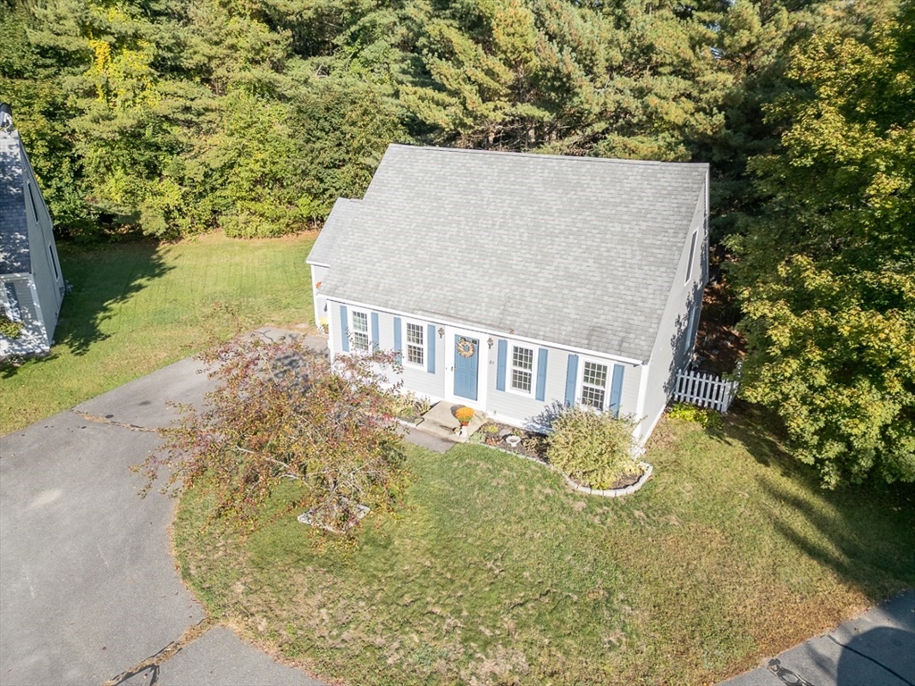 8 Tucker Park, Unit D Pepperell, MA 01463 - Photo 31 of 35 a view of a house with a yard