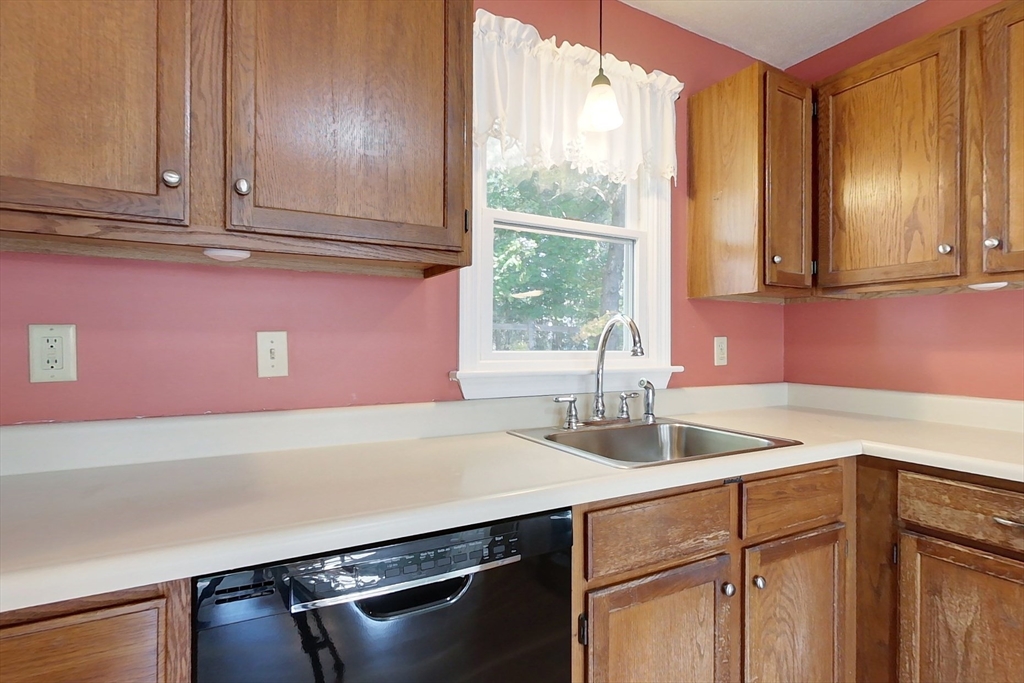 8 Tucker Park, Unit D Pepperell, MA 01463 - Photo 4 of 35 a kitchen with a sink cabinets and window