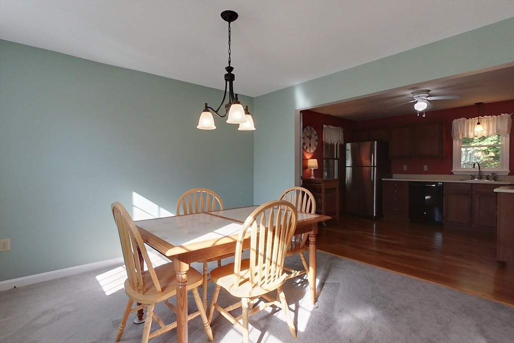 8 Tucker Park, Unit D Pepperell, MA 01463 - Photo 7 of 35 a dining room with furniture and chandelier