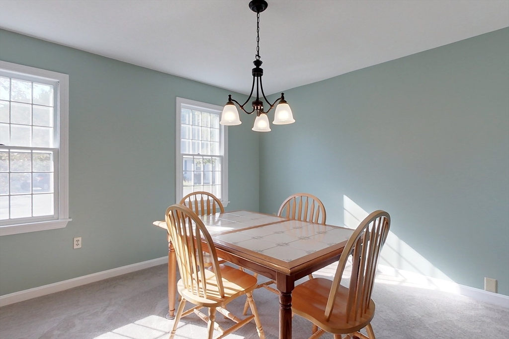 8 Tucker Park, Unit D Pepperell, MA 01463 - Photo 9 of 35 a view of a dining room with furniture window and outside view