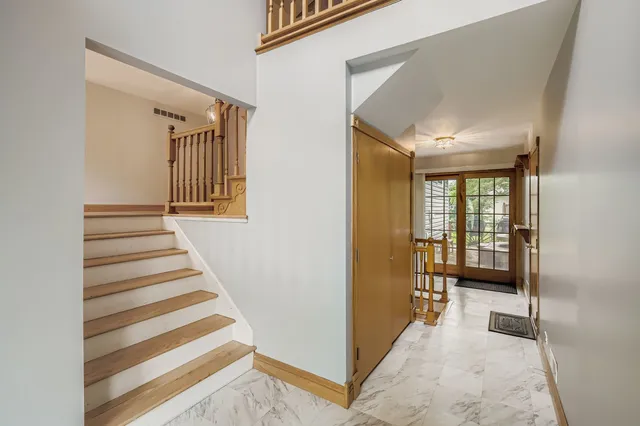 a view of a hallway with windows and stairs