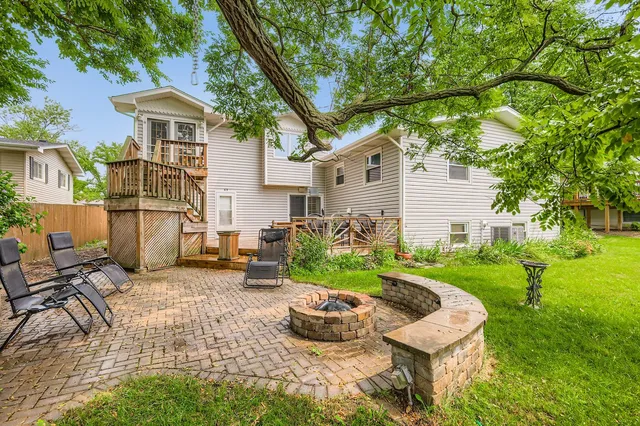 a view of a house with backyard sitting area and garden