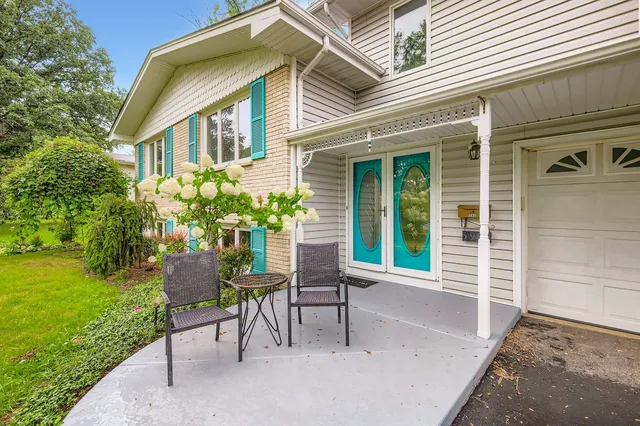 a view of a house with backyard and sitting area