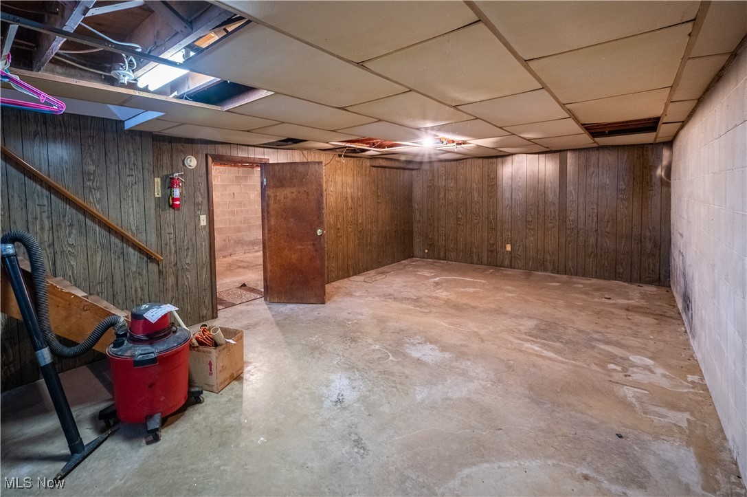 1329 Oak Grove Road Waverly, WV 26184 - Photo 20 of 29 Below grade area with wood walls and a paneled ceiling