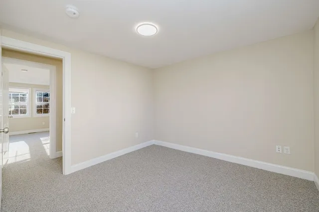 an empty room with a empty space and windows