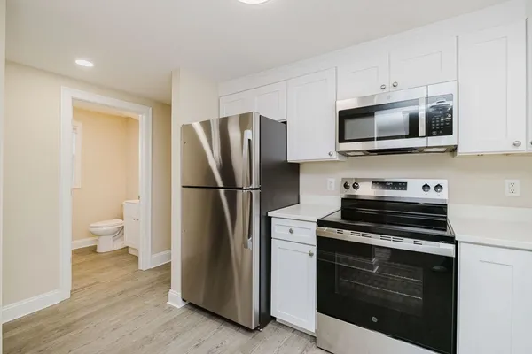 a kitchen with stainless steel appliances a refrigerator stove and microwave