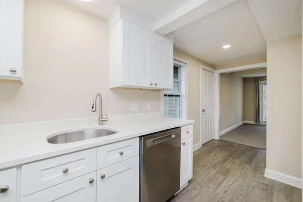 a kitchen with white cabinets