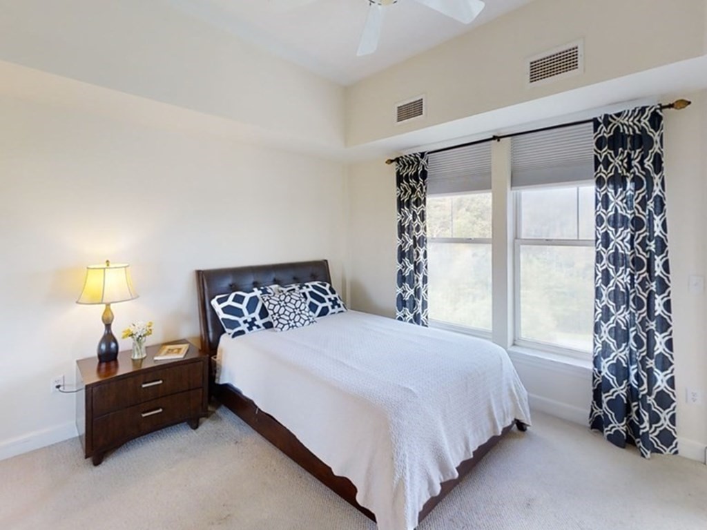 36 Village Road, Unit 713 Middleton, MA 01949 - Photo 15 of 39 a bedroom with a bed and a window