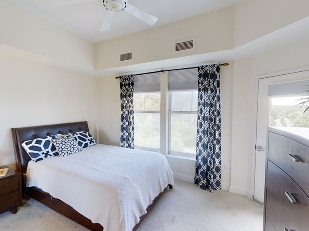 36 Village Road, Unit 713 Middleton, MA 01949 - Photo 16 of 39 a bedroom with a bed and a window